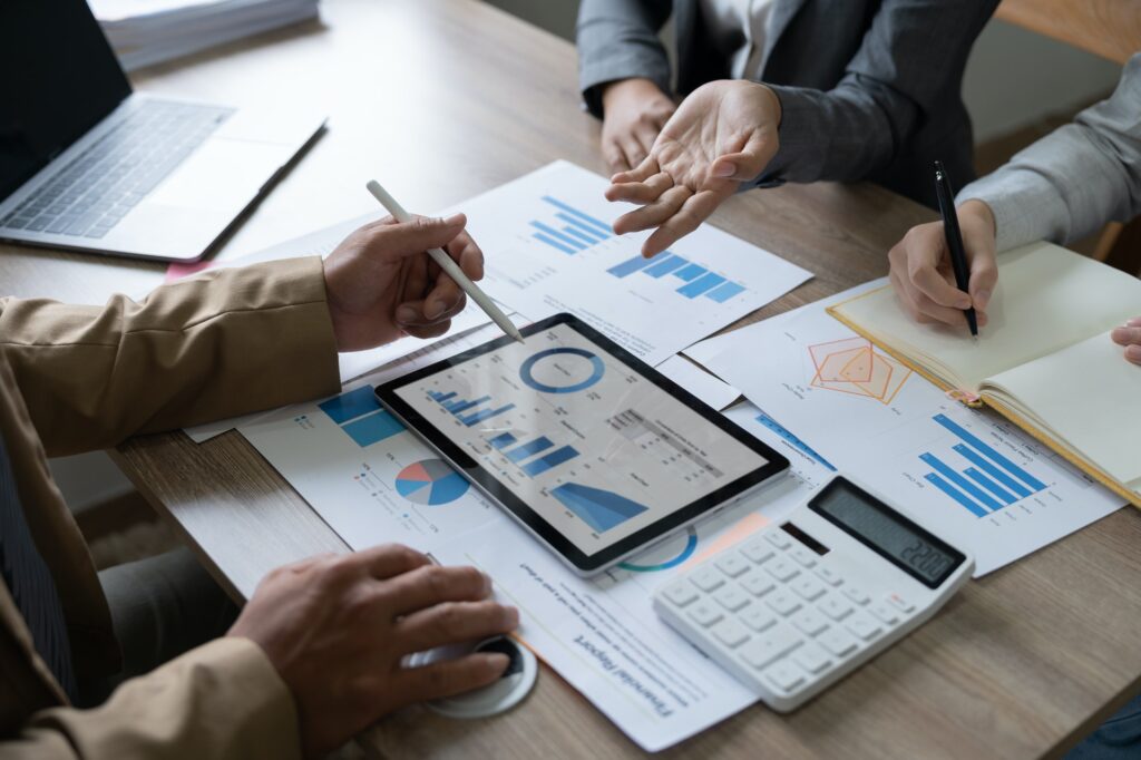 Business team brainstorming data target financial on digital tablet and paperwork